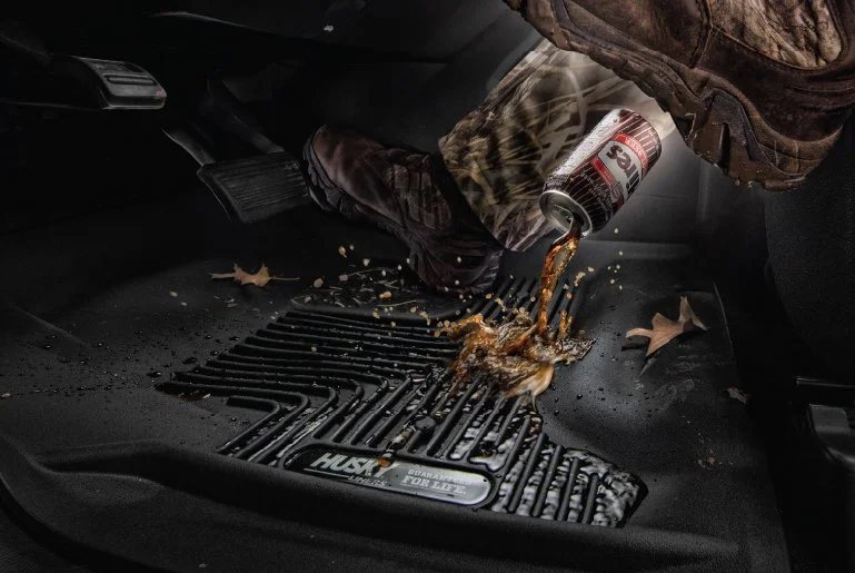 Husky Liners ad: a soda spills onto a Husky floor liner and stays in its channels, away from the truck's carpet.